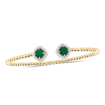 Luxury ladies bangle with emeralds and diamonds.